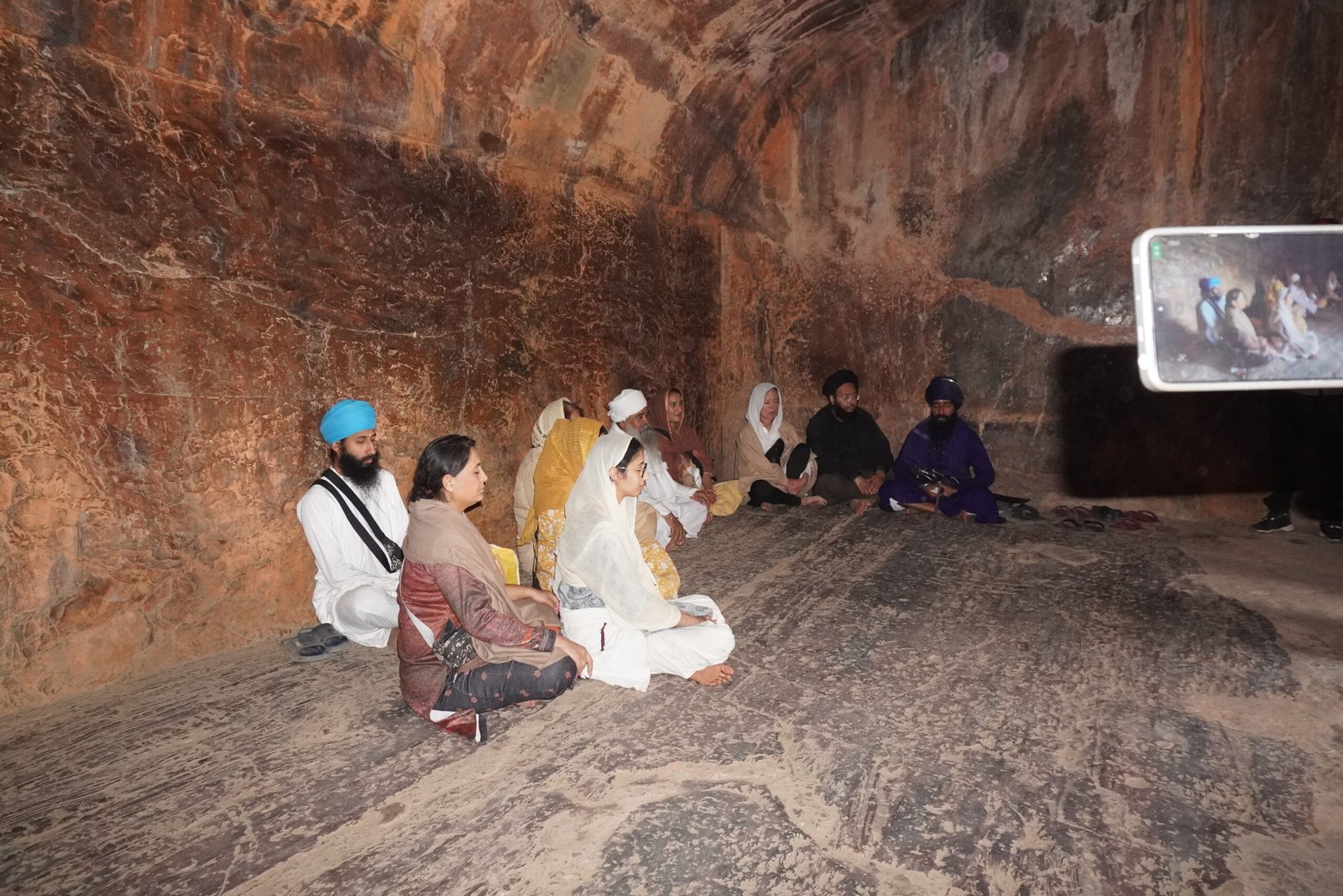 some sikkh people doing meditation on son bhandar cave 