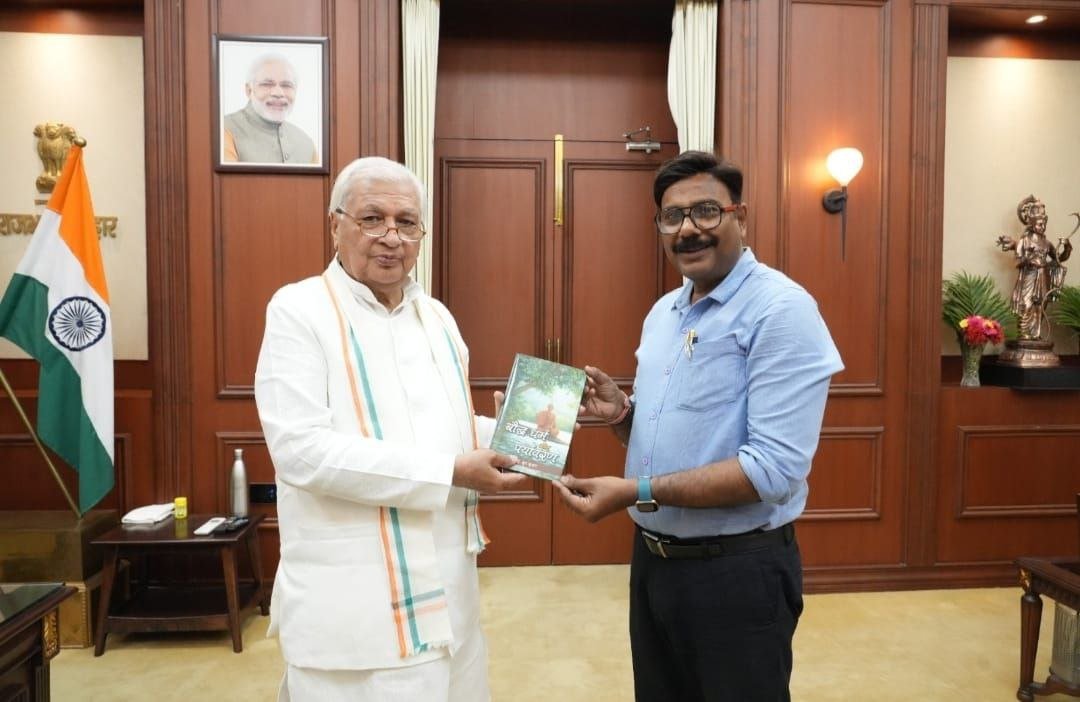 On World Book Day, author Dr. Dhruv presented his book 'Buddhism and Environment' to the Governor at Raj Bhavan