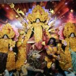 Devotional atmosphere at the Veer Balak Durga Puja Committee; devotees engaged in the worship of Goddess Durga.