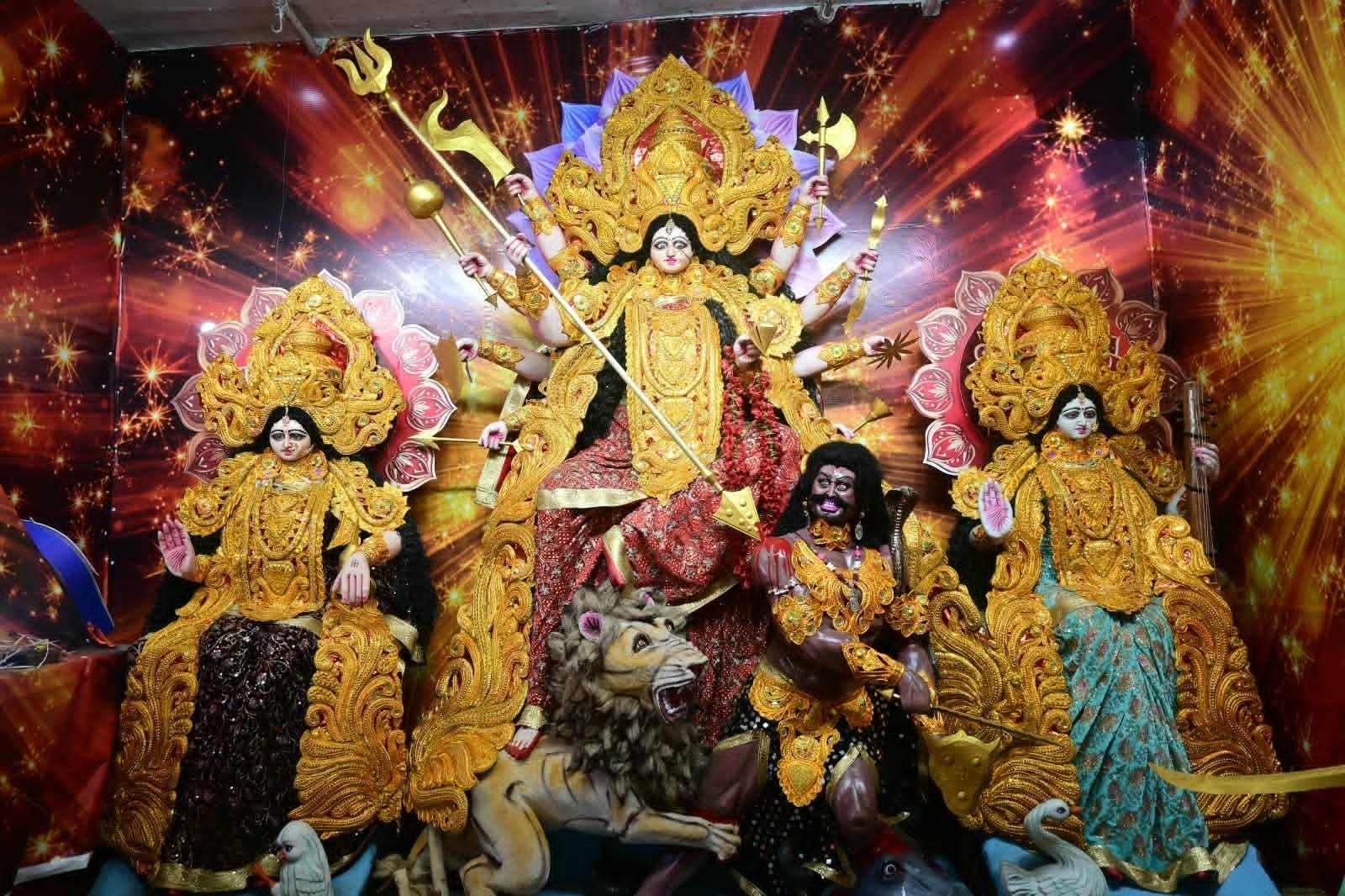 Devotional atmosphere at the Veer Balak Durga Puja Committee; devotees engaged in the worship of Goddess Durga.